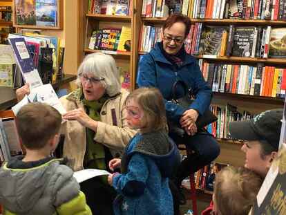 Kizzie, with author Avril van der Merwe, reading at Edmonds Bookshop.